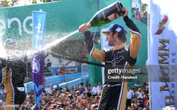 In this handout provided by FIA Formula E - Jean-Eric Vergne , TECHEETAH, Renault ZE 17, sprays the champagne on the podium during the Santiago...