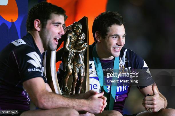 Storm captain Cameron Smith and Billy Slater pose with the trophy after winning the 2009 NRL Grand Final match between the Parramatta Eels and the...