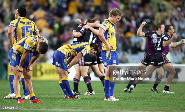 Eels players look dejected as Storm players celebrate after the 2009 NRL Grand Final match between the Parramatta Eels and the Melbourne Storm at ANZ...