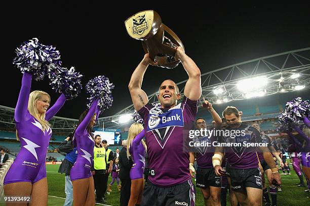 Steve Turner of the Storm walks off the field with the NRL Premiership trophy after winning the 2009 NRL Grand Final match between the Parramatta...