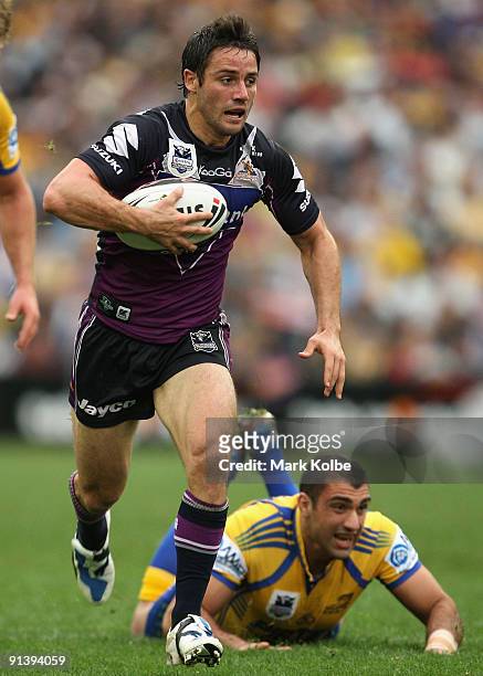 Cooper Cronk of the Storm makes a break during the 2009 NRL Grand Final match between the Parramatta Eels and the Melbourne Storm at ANZ Stadium on...