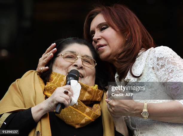 This file picture shows Argentine president Cristina Fernandez de Kirchner embracing popular singer Mercedes Sosa on the stage in front of the...
