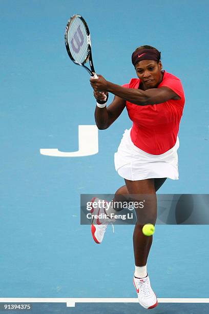 Serena Williams of USA returns a shot against Kaia Kanepi of Estonia in her first round match during day three of the 2009 China Open at the National...