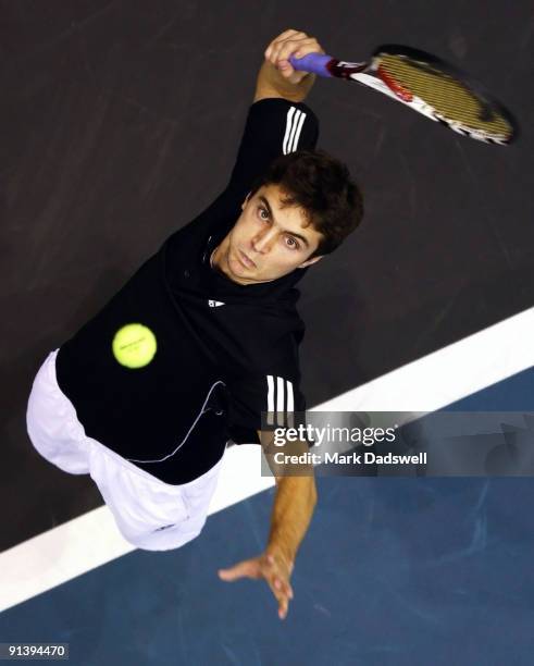 Gilles Simon of France serves in his singles finals match against Viktor Troiki of Serbia during day nine of the 2009 Thailand Open at Impact Arena...
