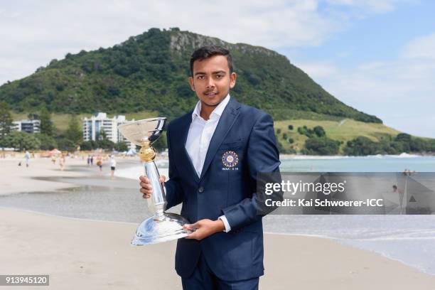 Captain Prithvi Shaw of India poses with the trophy during the ICC U19 Cricket World Cup media opportunity at Mount Maunganui Beach on February 4,...