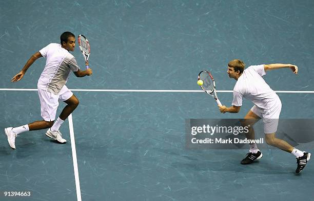 Rajeev Ram of the USA watches as partner Eric Butorac of the USA hits a backhand volley in their doubles final match against Guillermo Garcia-Lopez...