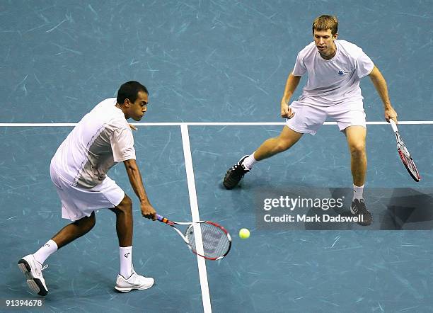 Rajeev Ram of the USA hits a backhand volley as partner Eric Butorac of the USA looks on in their doubles final match against Guillermo Garcia-Lopez...