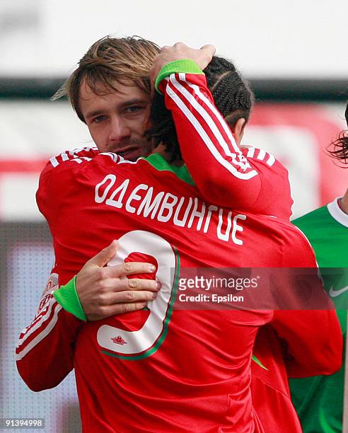 Dmitri Sychev and Peter Odemwingie of FC Lokomotiv Moscow celebrate after scoring a goal during the Russian Football League Championship match...