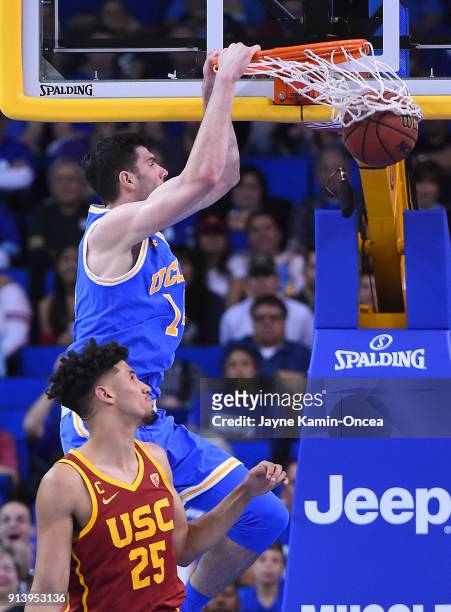 Gyorgy Goloman of the UCLA Bruins dunks over Bennie Boatwright of the USC Trojans in the second half at Pauley Pavilion on February 3, 2018 in Los...