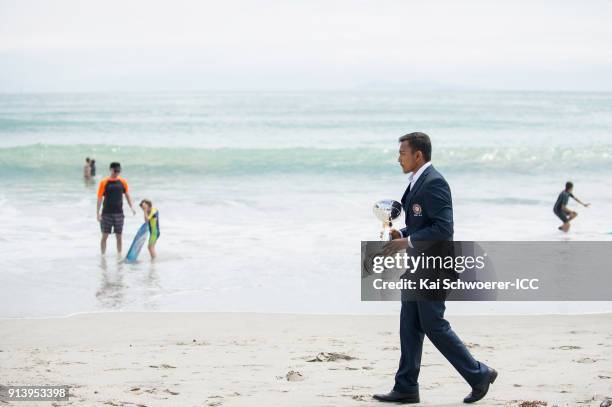 Captain Prithvi Shaw of India walks with the trophy during the ICC U19 Cricket World Cup media opportunity at Mount Maunganui Beach on February 4,...