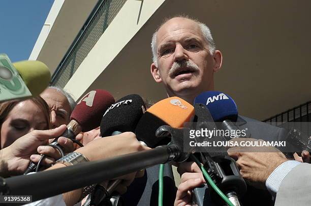 Greek socialist PASOK party leader George Papandreou talks to the media after casting his vote for the general elections in Athens on October 4,...