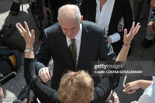 Greek socialist PASOK party leader George Papandreou is greeted by his supporters prior to casting his vote for the Greek general elections in Athens...