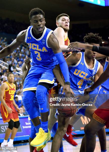 Aaron Holiday of the UCLA Bruins, Nick Rakocevic of the USC Trojans and Jaylen Hands of the UCLA Bruins battle for a rebound in the second half at...