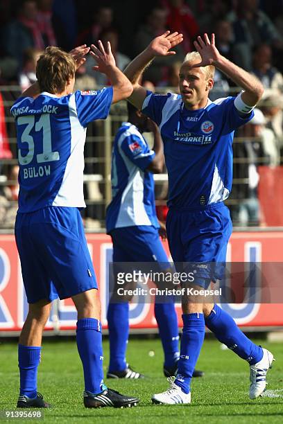 Tim Sebastian of Rostock celebrates scoring his team's second goal with team mate Kai Buelow during the Second Bundesliga match between Rot-Weiss...