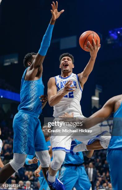 Kaiser Gates of the Xavier Musketeers shoots the ball against Jessie Govan of the Georgetown Hoyas at Cintas Center on February 3, 2018 in...