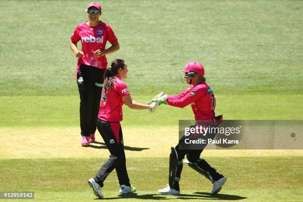Sarah Coyte and Alyssa Healy of the Sixers celebrate the wicket of Heather Graham of the Scorchers during the Women's Big Bash League final match...