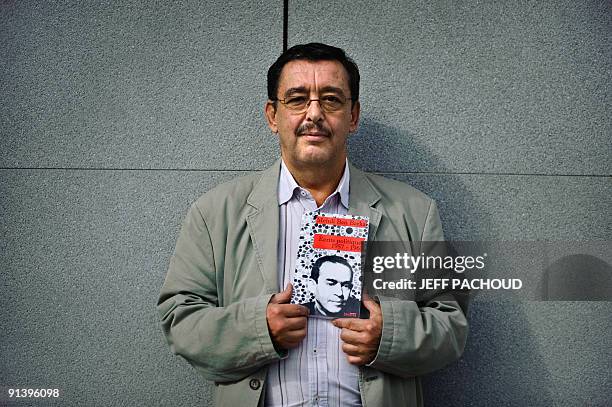 Bechir Ben Barka, the son of Moroccan opposition leader Mehdi Ben Barka abducted in 1965, poses with a book "Ecrits politiques " , written by his...