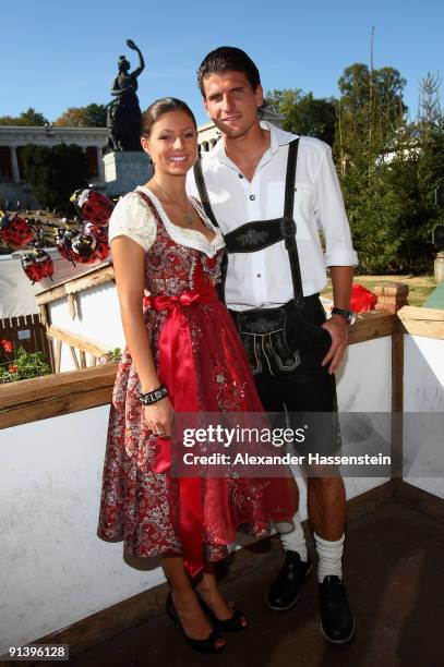 Mario Gomez of Bayern Muenchen and girlfriend Silvia Meichel attend the Oktoberfest beer festival at the Kaefer Wiesnschaenke tent on October 4, 2009...