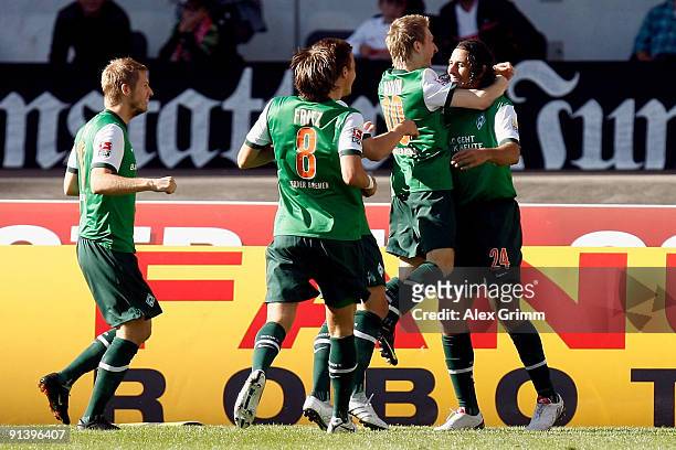 Claudio Pizarro celebrates scoring his team's first goal with team mates Marko Marin, Mesut Oezil, Clemens Fritz and Aaron Hunt of Bremen during the...
