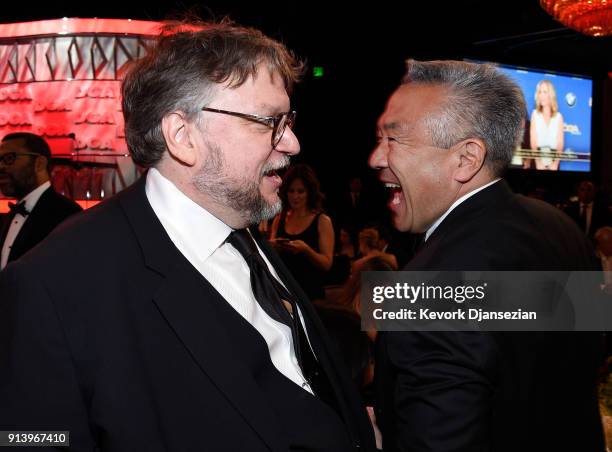 Director Guillermo del Toro and chairman and CEO of Warner Bros. Entertainment Kevin Tsujihara speak in the audience during the 70th Annual Directors...