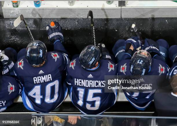 Joel Armia, Matt Hendricks and Nikolaj Ehlers of the Winnipeg Jets look on from the bench during third period action against the Tampa Bay Lightning...