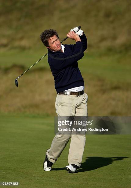 Actor Hugh Grant plays his second shot on the fifth hole during the third round of The Alfred Dunhill Links Championship at Kingsbarns Golf Links on...