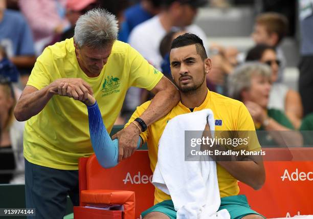 Nick Kyrgios of Australia receives medical treatment in the match against Alexander Zverev of Germany during the Davis Cup World Group First Round...