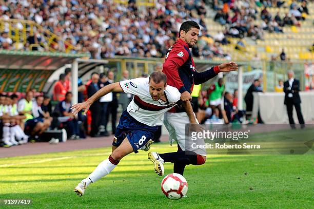 Rodrigo Sebastian Palacio of Genoa CFC competes the ball with Miguel Angel Britos of Bologna FC during the Serie A match between Bologna FC and Genoa...