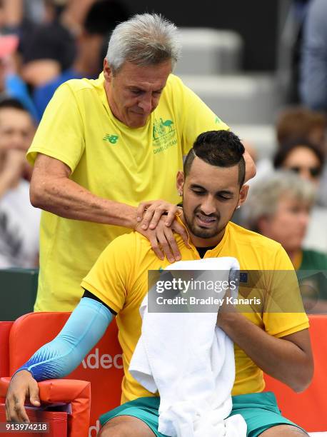 Nick Kyrgios of Australia receives medical treatment in the match against Alexander Zverev of Germany during the Davis Cup World Group First Round...