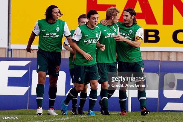 Aaron Hunt of Bremen celebrates scoring his team's second goal with team mates Mesut Oezil , Claudio Pizarro and Torsten Frings during the Bundesliga...
