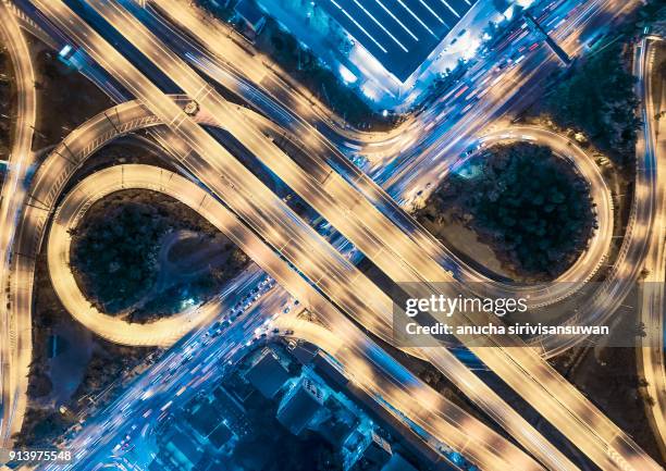 aerial top view, roundabout road car lights speed in city at night, eyes abstract art, multiple roads in bangkok, cheang wattana road, bangkok, thailand. - flyovers stock pictures, royalty-free photos & images