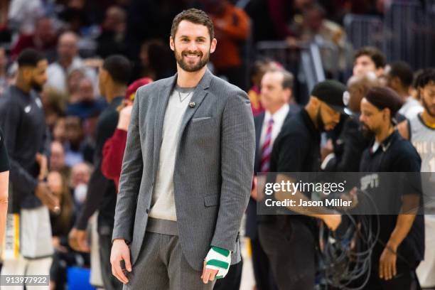 Kevin Love of the Cleveland Cavaliers talks to players on the Houston Rockets bench during a time-out during the second half at Quicken Loans Arena...