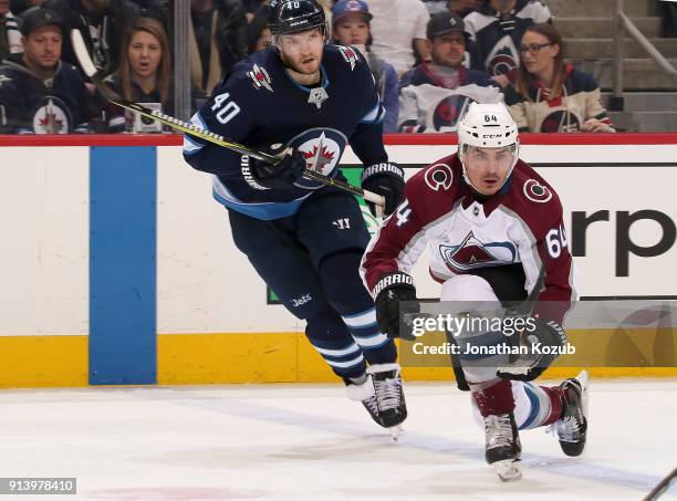 Joel Armia of the Winnipeg Jets and Nail Yakupov of the Colorado Avalanche keep an eye on the play during third period action at the Bell MTS Place...