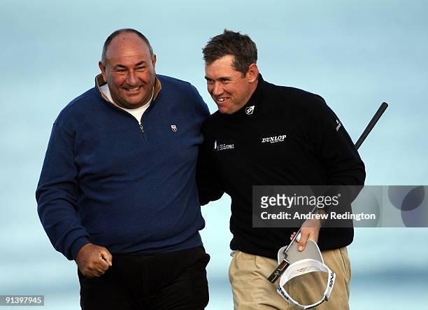 Lee Westwood of England with his playing a partner Andrew 'Chubby' Chandler on the 18th green during the third round of The Alfred Dunhill Links...