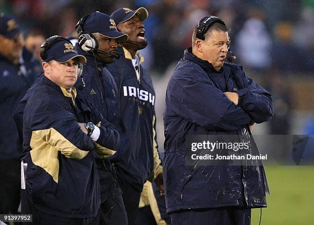 Head coach Charlie Weis of the Notre Dame Fighting Irish and his staff watch as their team takes on the Washington Huskies on October 3, 2009 at...