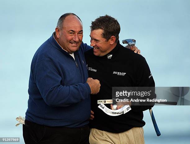 Lee Westwood of England with his playing a partner Andrew 'Chubby' Chandler on the 18th green during the third round of The Alfred Dunhill Links...
