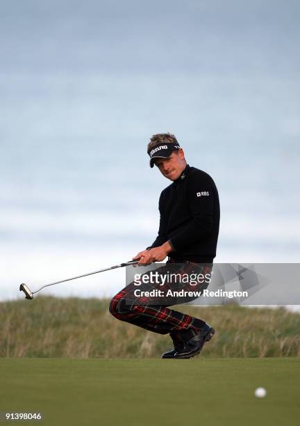 Luke Donald of England reacts after just missing his putt on the 18th green during the third round of The Alfred Dunhill Links Championship at...