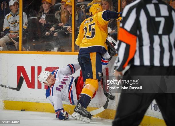 Alexei Emelin of the Nashville Predators checks Cody McLeod of the New York Rangers during an NHL game at Bridgestone Arena on February 3, 2018 in...