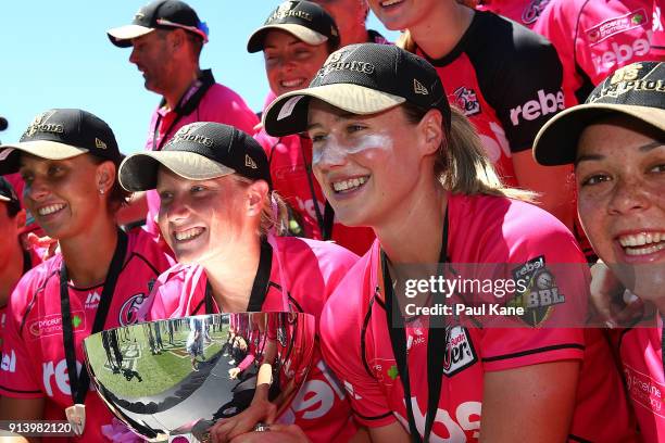 Alyssa Healy and Ellyse Perry of the Sixers pose with the trophy after winning the Women's Big Bash League final match between the Sydney Sixers and...