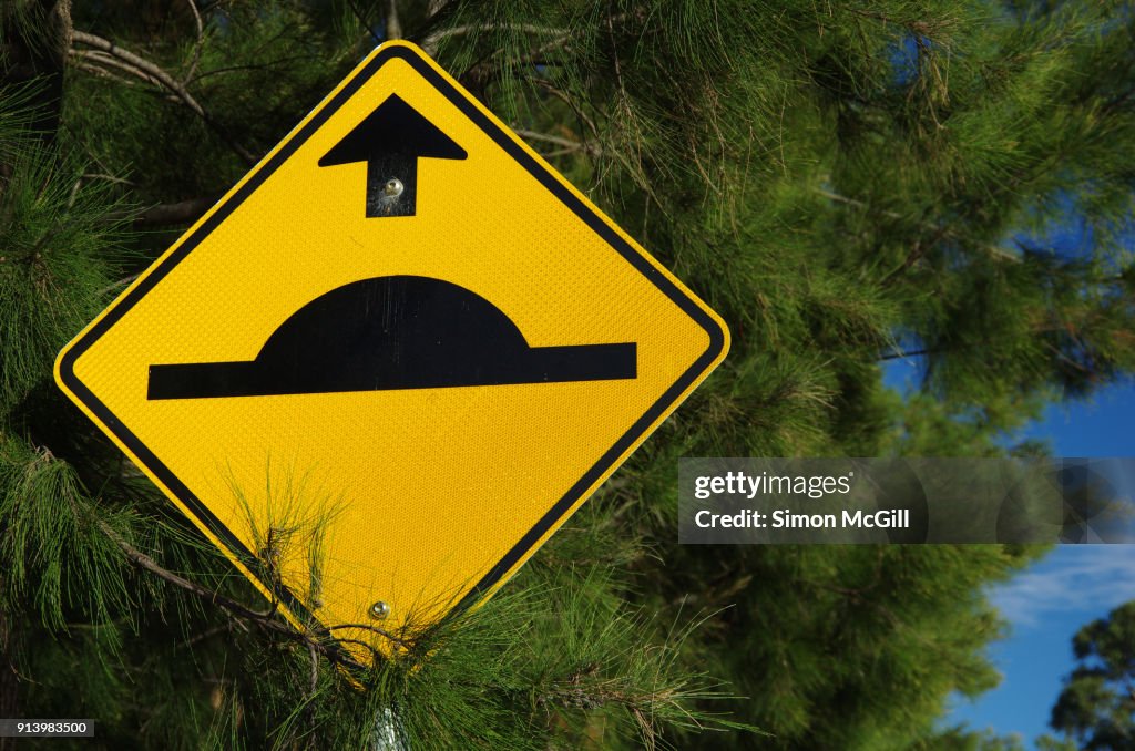Speed bump ahead traffic warning sign