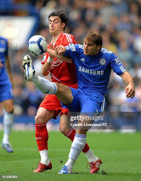 Albert Riera of Liverpool competes with Branislav Ivanovic of Chelsea during the Barclays Premier League match between Chelsea and Liverpool at...
