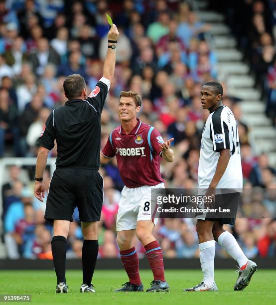 Scott Parker of West Ham looks disappointed as he is booked by referee Phil Dowd during the Barclays Premier League match between West Ham United and...