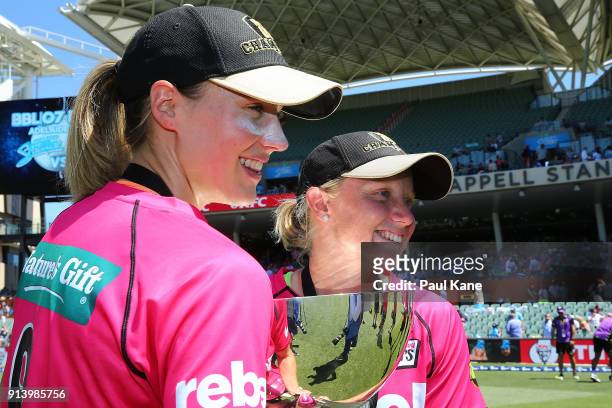 Ellyse Perry and Alyssa Healy of the Sixers pose with the trophy after winning the Women's Big Bash League final match between the Sydney Sixers and...