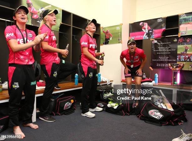 Sarah Coyte, Kim Garth, Alyssa Healy and Ellyse Perry of the Sixers sing the team song after winning the Women's Big Bash League final match between...