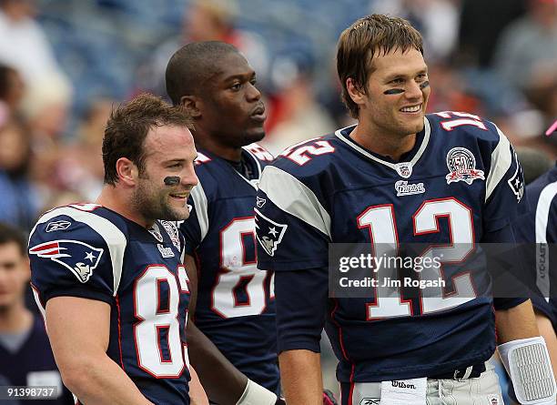 Wes Welker, Benjamin Watson, and Tom Brady of the New England Patriots, stand on the sideline before a game with the Baltimore Ravens at Gillette...