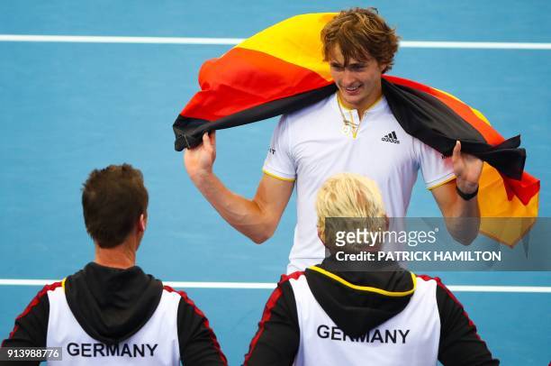 Alexander Zverev of Germany and his team celebrate his victory over Nick Kyrgios of Australia following their forth round rubber of the Davis Cup...