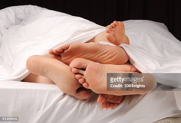 people on the bed - woman lying on stomach with feet up stock pictures, royalty-free photos & images