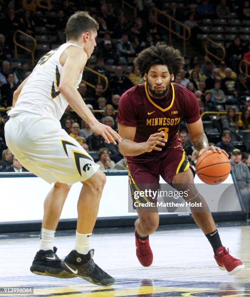 Forward Jordan Murphy of the Minnesota Gophers drives to the basket in the first half against forward Luka Garza of the Iowa Hawkeyes on January 30,...