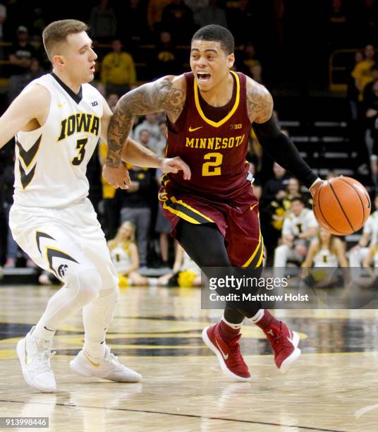 Guard Nate Mason of the Minnesota Gophers drives down the court in the first half against guard Jordan Bohannon of the Iowa Hawkeyes on January 30,...