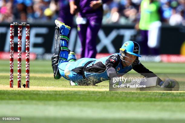 Alex Carey of the Strikers dives to avoid a run-out during the Big Bash League Final match between the Adelaide Strikers and the Hobart Hurricanes at...